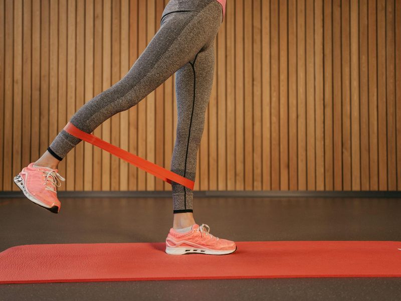 Athletic sneakers moving on a gray gym floor with focus on motion