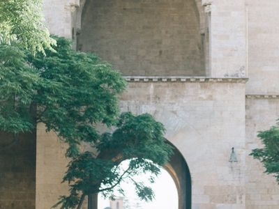Person standing on one leg with arms out in balance