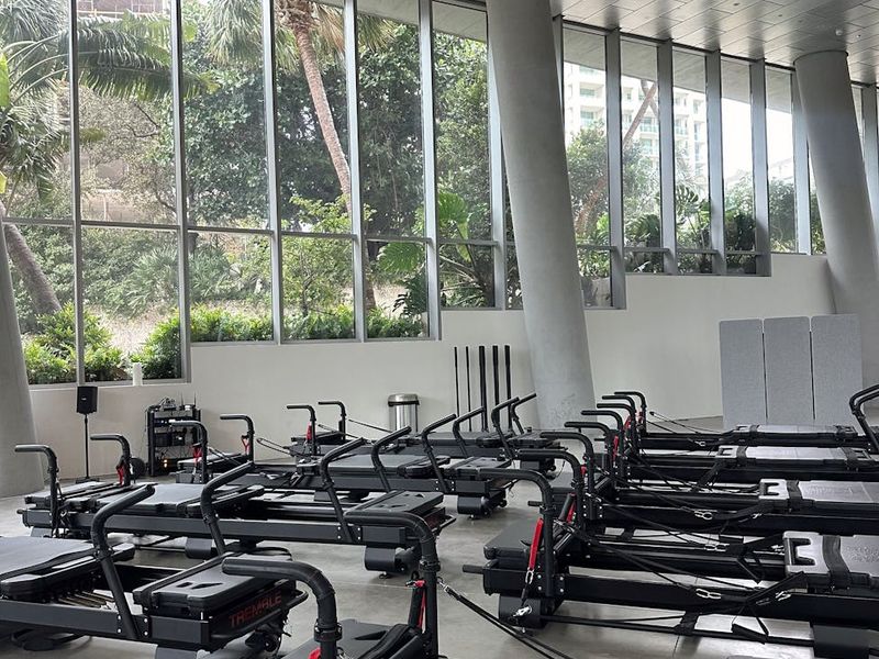 Spacious modern gym with large windows and minimalist equipment